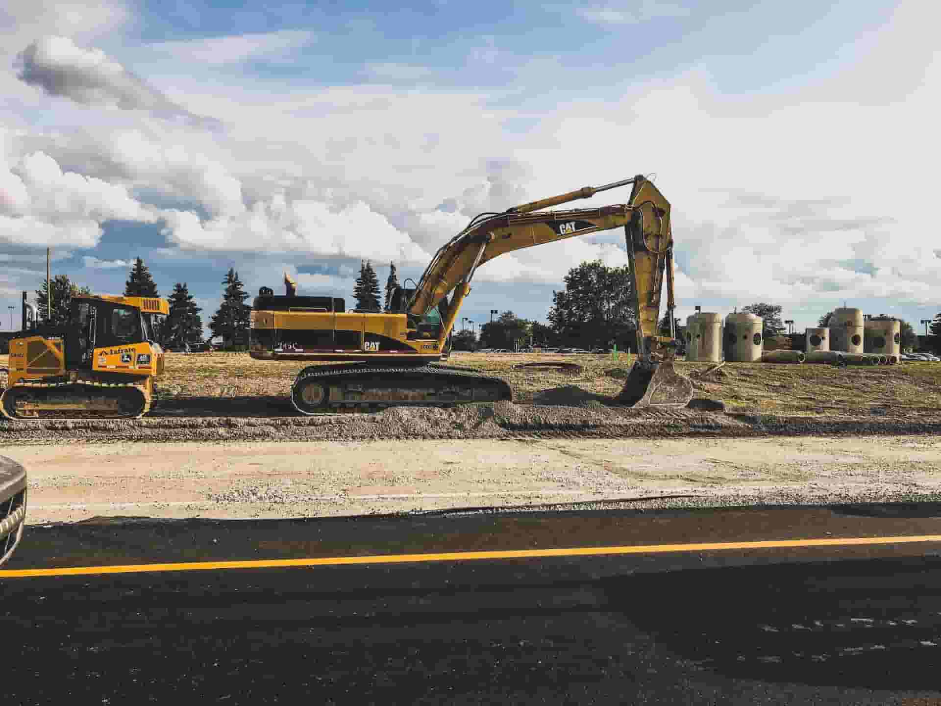 An excavator working by the side of a road